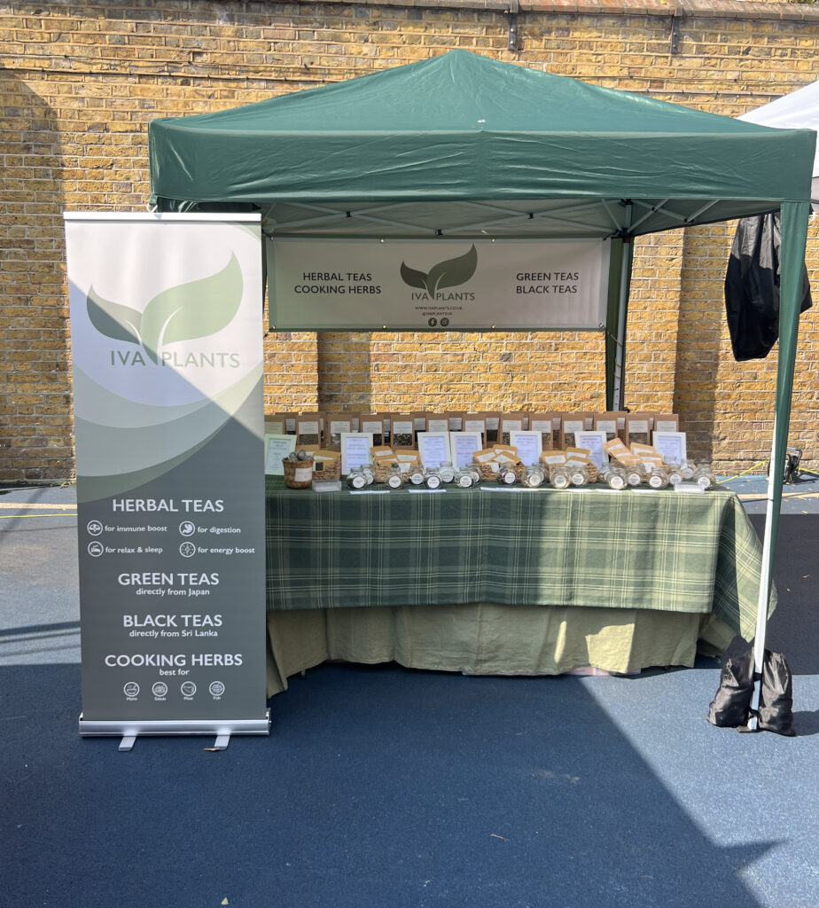 IVA Plants stall at Brook Green Market with a gazebo, displaying herbal, Japanese green, and black Ceylon teas