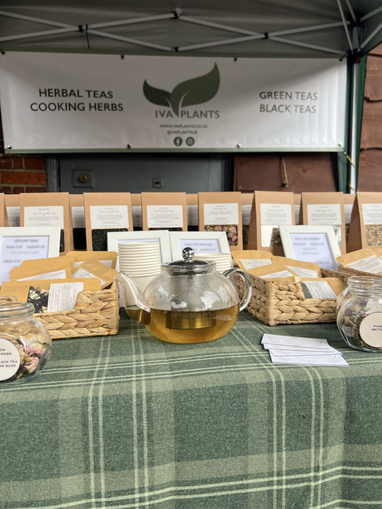 IVA Plants stall at Brook Green Market with a gazebo, displaying herbal, Japanese green, and black Ceylon teas